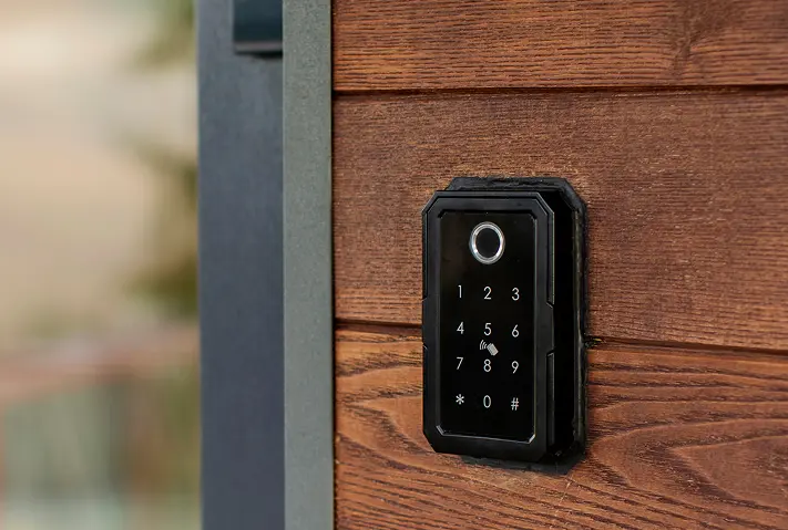 Electronic keypad lock mounted on a wood safe room door