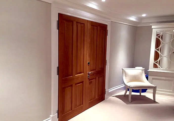 Ornate wooden gun-room door with discreet locking hardware