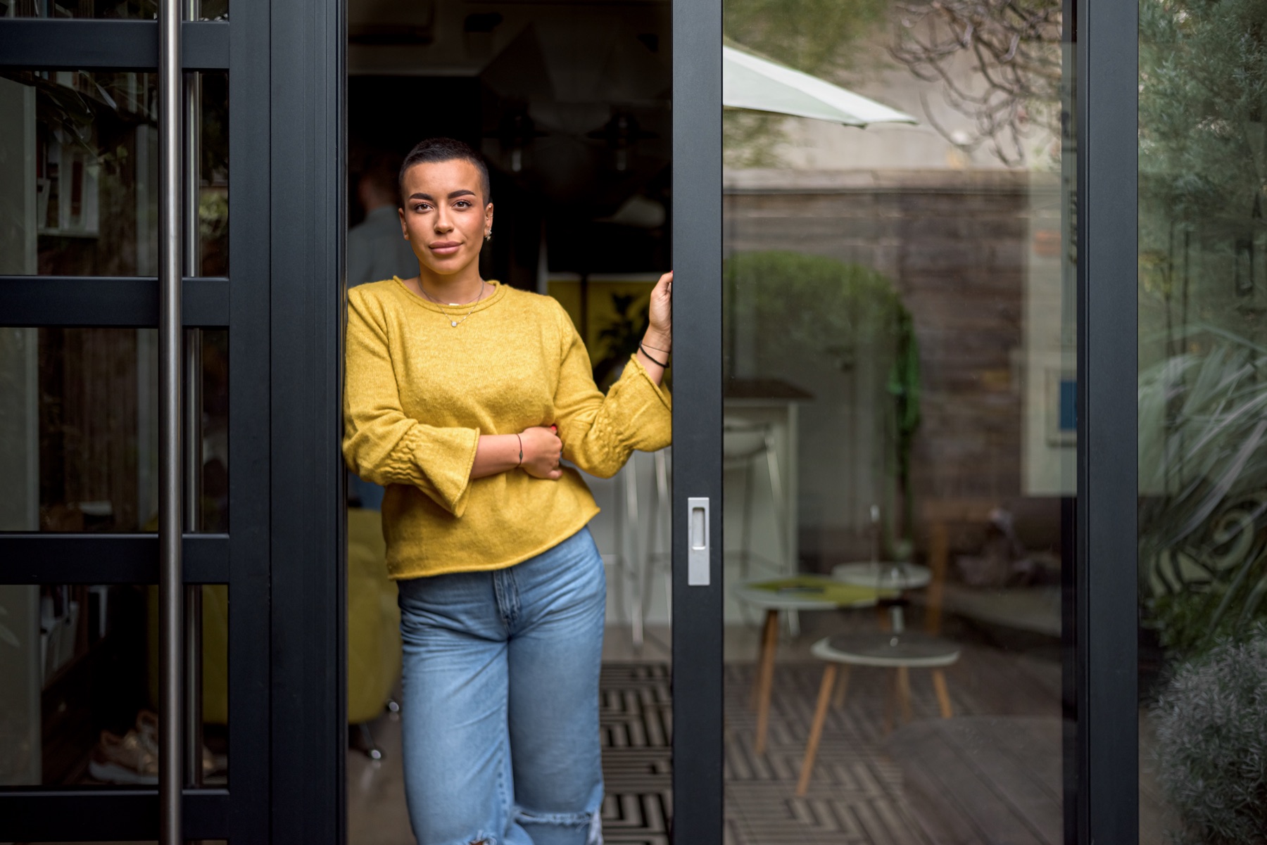 Resident opening a contemporary glazed entrance door