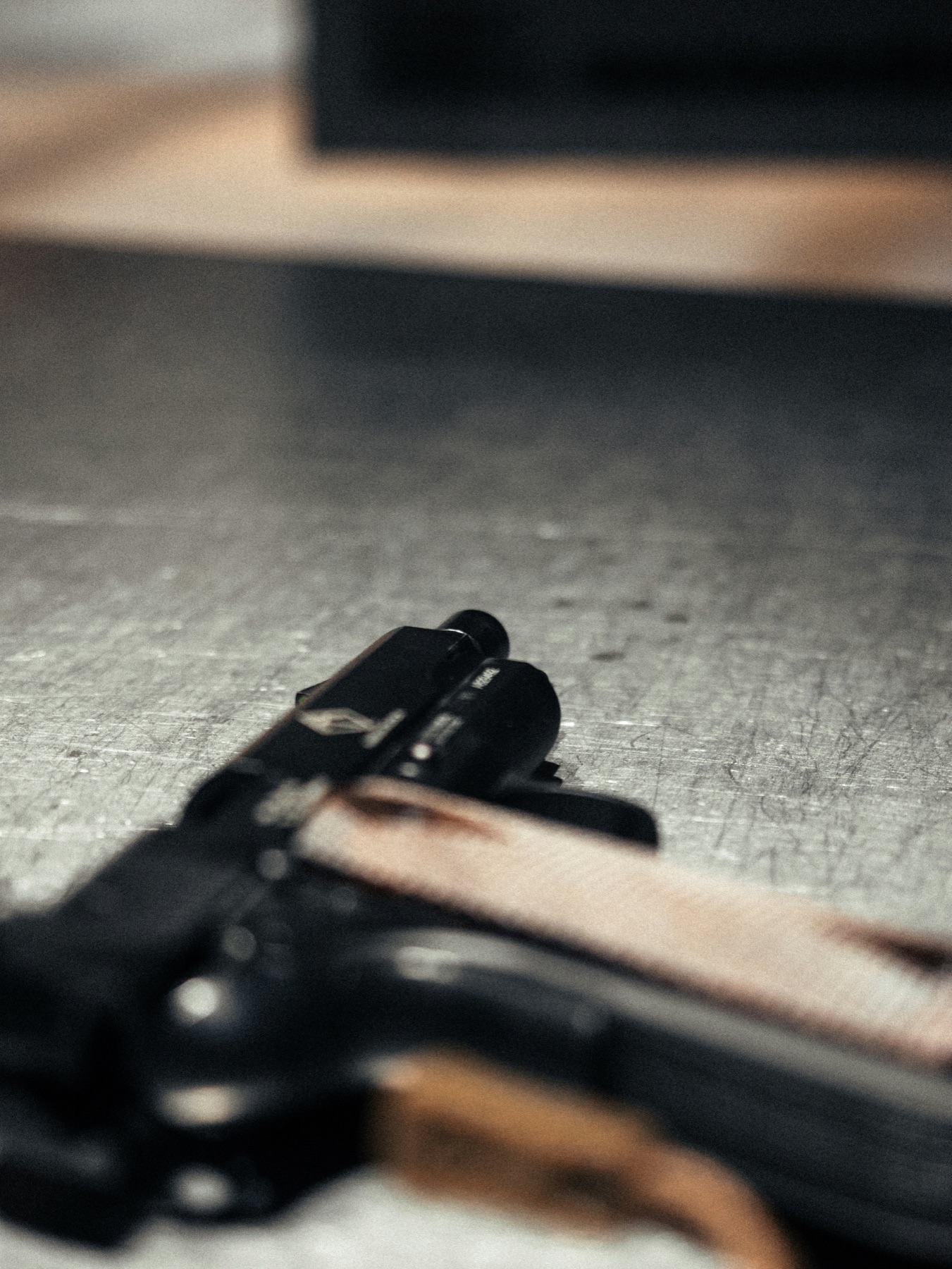 Close view of a firearm resting on a work surface
