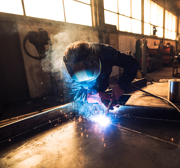 person welding in mask